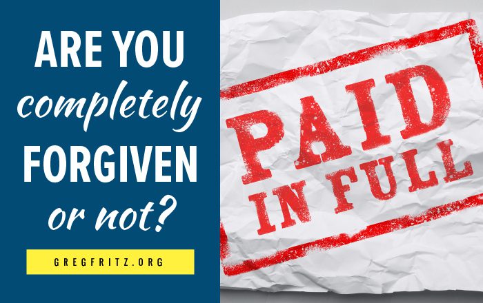 Paid in full stamp on paper, along with the words: Are you completely forgiven or not?